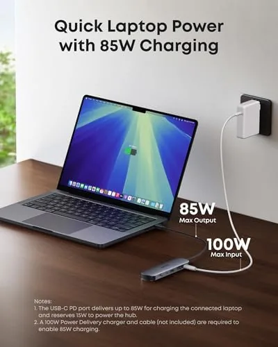 The hub packed into a laptop bag pocket with a charger and cable