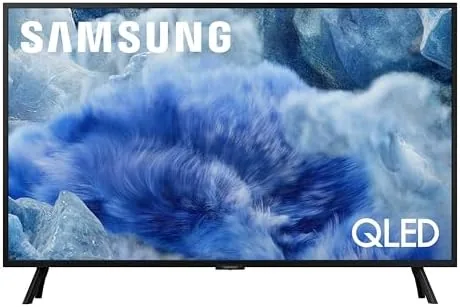 The 32 inch Samsung QLED Q8F sitting on a bedroom dresser showing a colorful scene