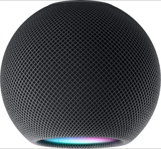 HomePod mini in a living room with a phone showing Handoff