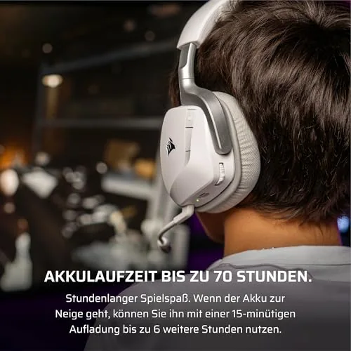 The headset hanging on a hook next to a PC setup with a monitor