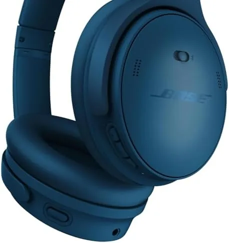 A traveler wearing the Bose QuietComfort headphones while boarding a flight