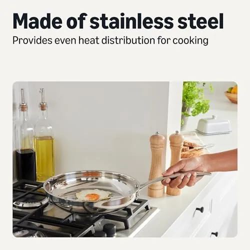 Searing chicken in the stainless steel frying pan with oil