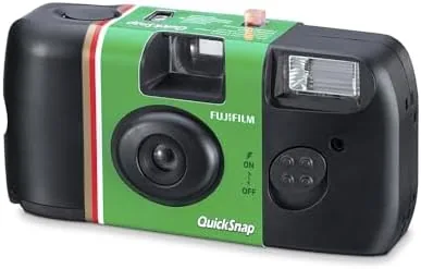The QuickSnap camera packed beside a passport and travel notebook