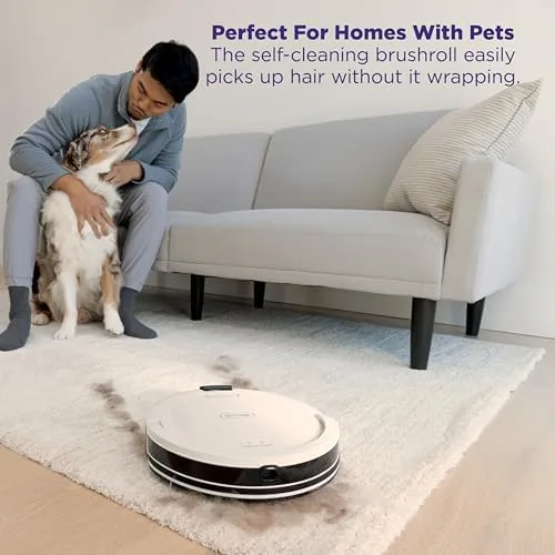 The robot vacuum docked at its charging base in a corner of a room