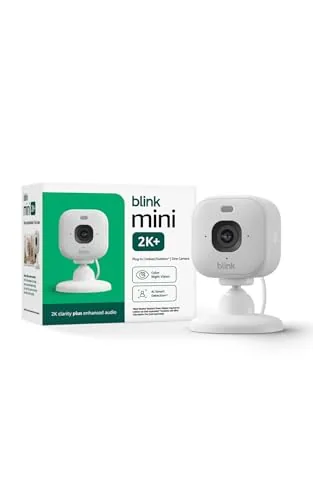 Close up of the Blink Mini 2K+ lens and status light on a white shelf