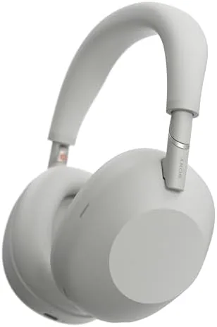 Sony WH-1000XM6 headphones in silver on a hotel desk