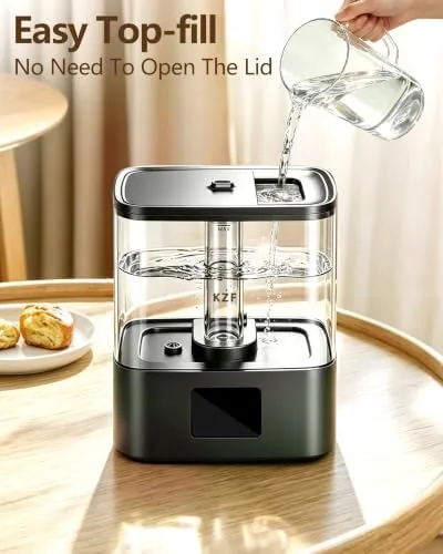 Humidifier running beside a crib at night with the humidity display glowing softly
