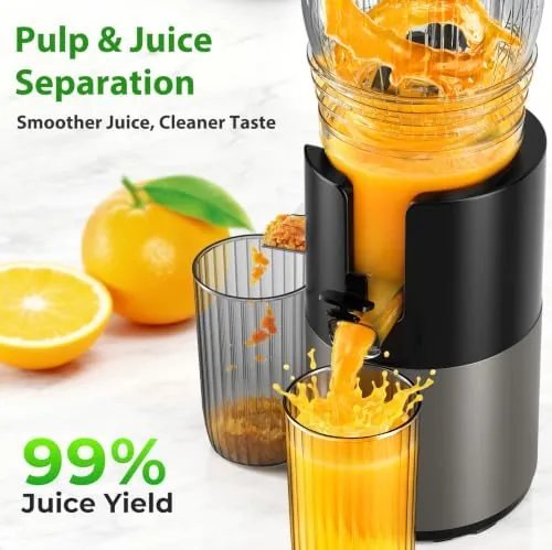 Glass of fresh apple juice beside the juicer with the dry pulp cup removed