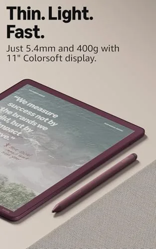 The Kindle Scribe Colorsoft open on a book page in a dim room
