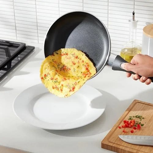A home cook flipping an egg in the Amazon Basics frying pan