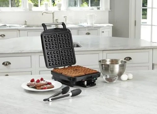 Four golden square waffles fresh from the machine on a plate