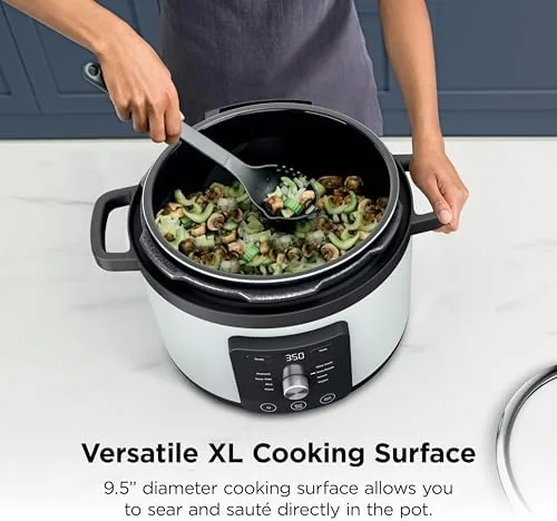 Braised beef lifted out of the pot, fork tender after pressure cooking