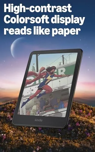 Reader holding the Kindle Colorsoft in one hand in soft daylight