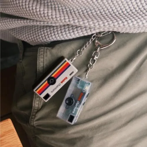 The keychain camera compared side by side with a smartphone and a point and shoot