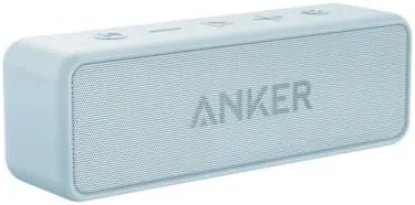 The Baby Blue Soundcore 2 speaker on a patio table with soft daylight behind it