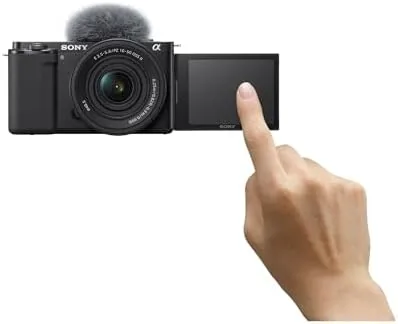 The camera showing the flip-out screen facing forward during a vlog setup