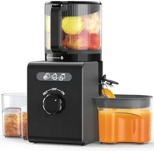 The black cold press juicer assembled on a counter with a whole apple beside the feed chute