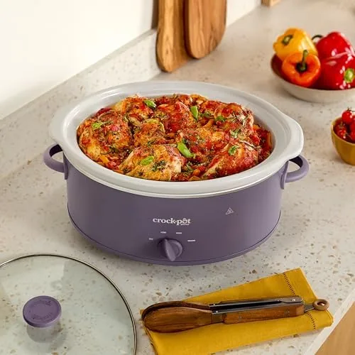 The slow cooker serving a family meal on a dining table in the evening