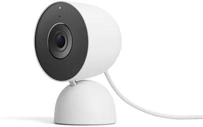 The Google Nest Cam Indoor Wired 3rd Gen in snow white on a bookshelf in a living room