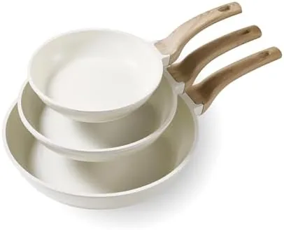 The three CAROTE skillets in cream white arranged on a stovetop