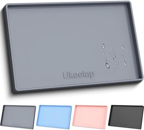 Gray extra thick silicone pet feeding mat with raised edge on a kitchen floor