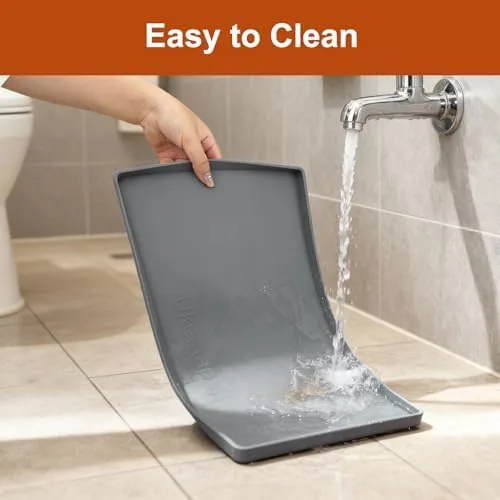 Silicone mat being rinsed clean under running water