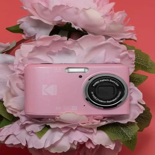 A child holding the pink FZ45 camera up to take a photo at a family event