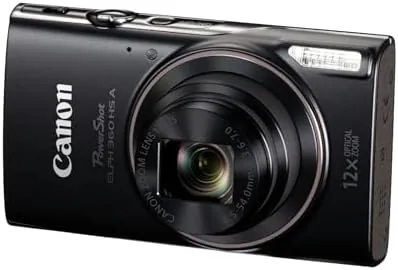 The camera charging on a desk beside a phone showing the Wi-Fi transfer app