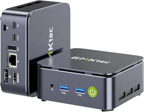 The GMKtec G10 mini PC sitting on a desk beside a monitor
