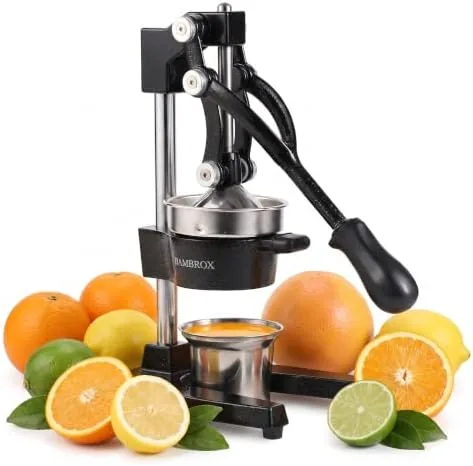 The black cast iron lemon squeezer sitting on a kitchen counter with citrus fruit