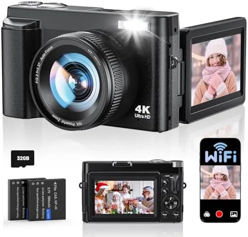 The compact 4K digital camera with its flip screen open on a table