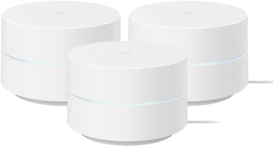 Three Google WiFi pucks lined up on a shelf in the snow white finish