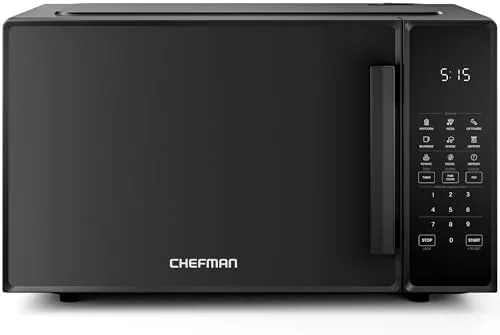 The black Chefman countertop microwave oven standing on a kitchen counter