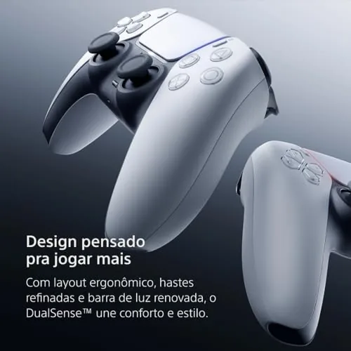 DualSense controller on a desk next to a laptop and phone