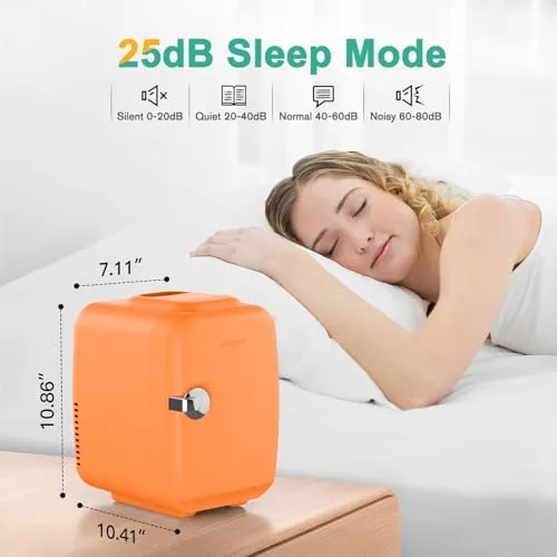 The orange mini fridge on a bedroom nightstand with a warm lamp