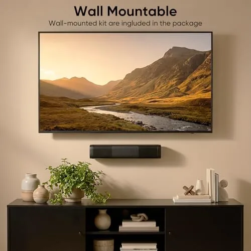 The sound bar connected to a laptop on a desk with music playing