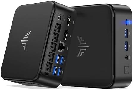 KAMRUI E3B mini PC sitting on a desk beside a keyboard and monitor