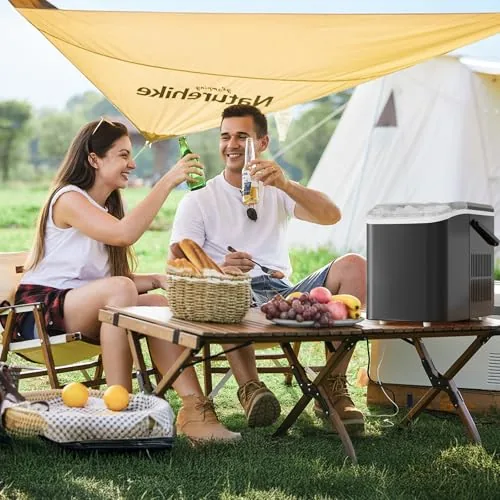 The ice maker on a camper table with the handle visible and ice filling the basket