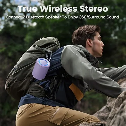 The speaker strapped to a backpack on a hiking trail