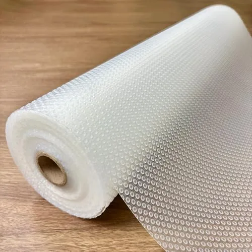 A roll of EVALAND clear shelf liner unrolled across a kitchen counter