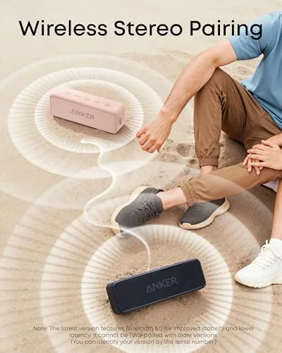 The speaker playing outdoors on a backyard table