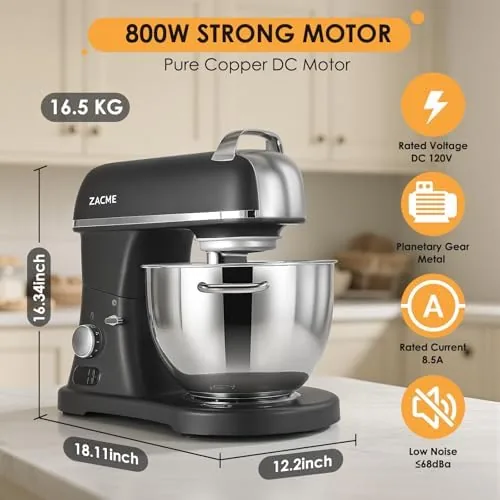 The mixer sitting in a commercial kitchen with bowls and attachments nearby