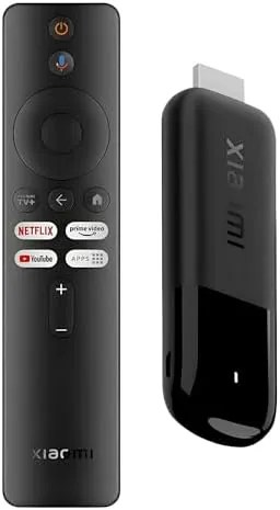 The small Xiaomi TV Stick 4K plugged into the HDMI port of a TV with the remote beside it