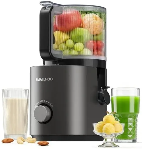 The silver 3-in-1 cold press juicer with a whole apple and juice glasses on the counter