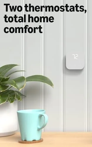 The Amazon Smart Thermostat mounted on a wall next to a Ring doorbell on the door