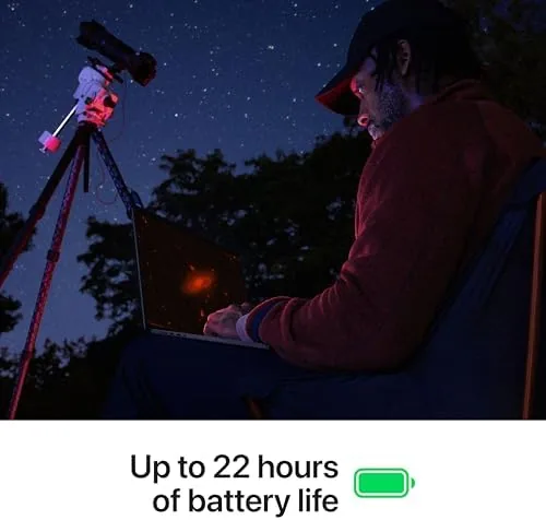 The MacBook Pro on a desk with an 8K video timeline open and export progress visible