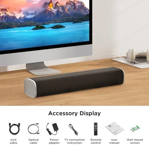 The sound bar set up on a media stand in a bedroom with a television above