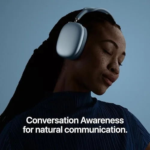 AirPods Max 2 in Starlight on a coffee table next to a book