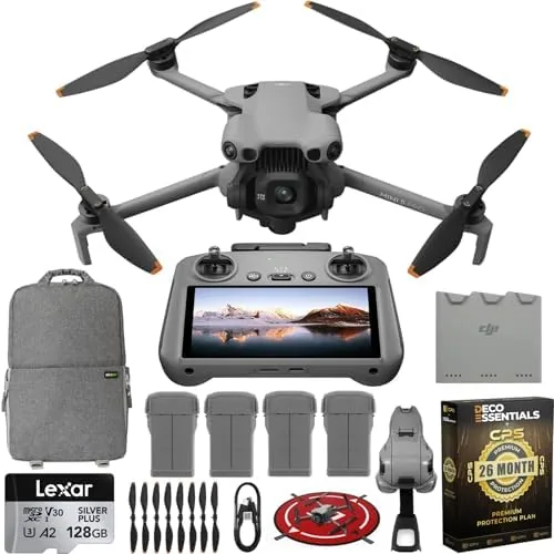 The DJI Mini 5 Pro drone beside its RC 2 controller and four batteries