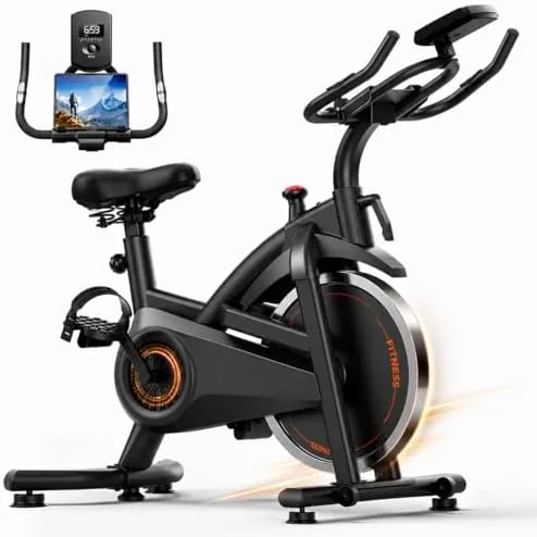 The CURSOR FITNESS exercise bike set up in a home living room